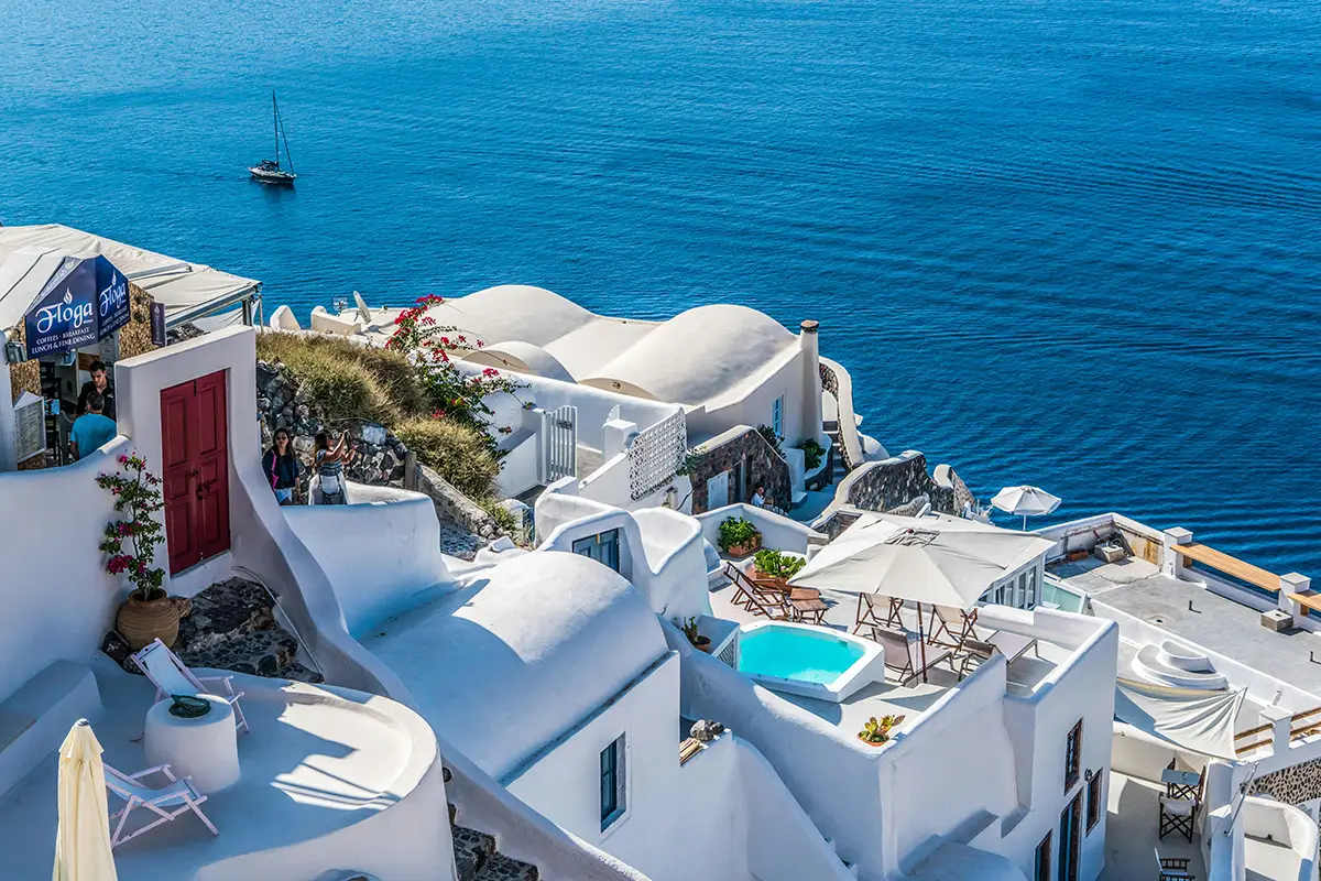 White cliffside villas overlooking the blue sea.