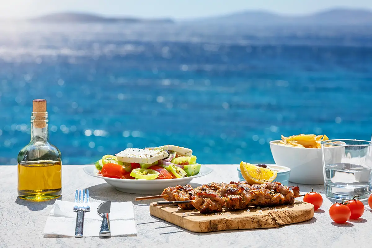 Table served with Greek food by Aegean Sea