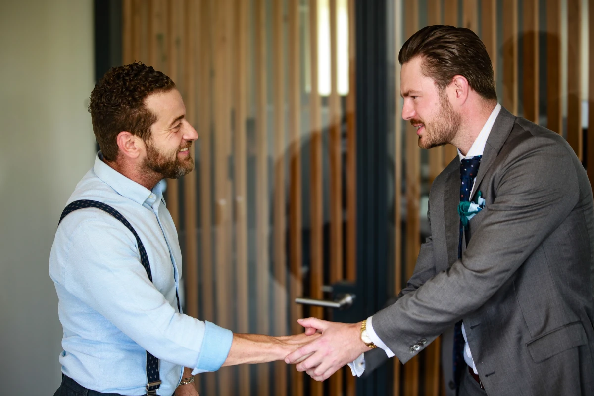 Investment Visa experts, João Bosco and George Hobson, shaking hands.