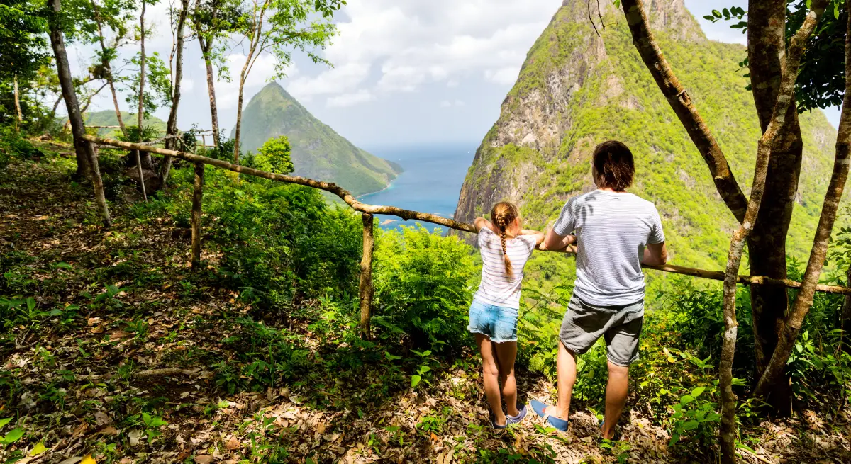 Father and daughter admire the Piton Mountains in Saint Lucia.