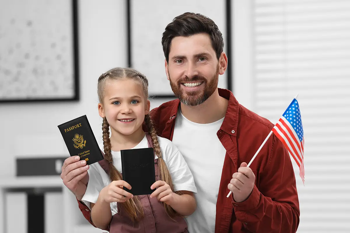 American father and daughter showing dual passports.